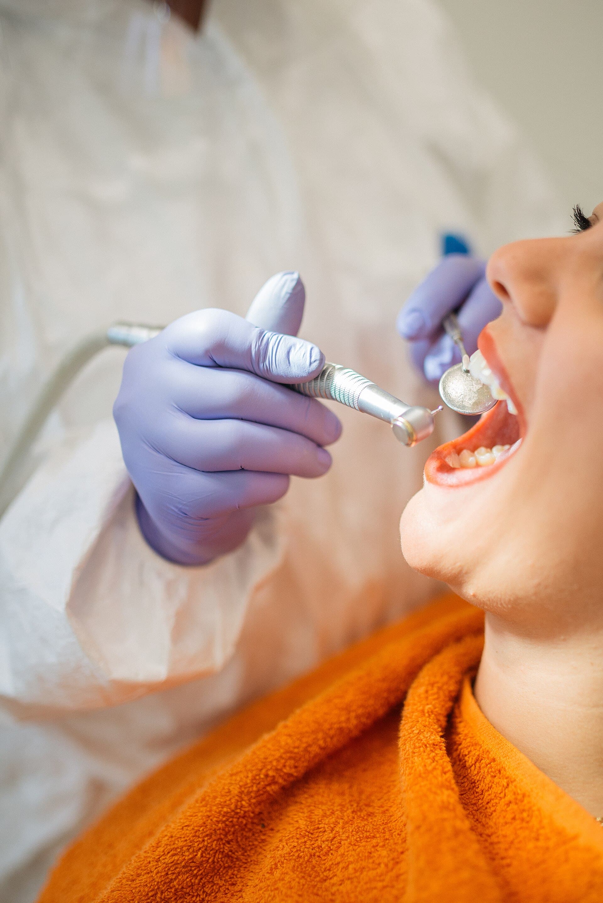 A dentist adjusting braces for a patient